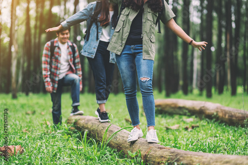 Group of traveler walking on the log while hiking in the forest Tableau sur Toile