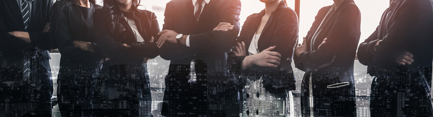Wall Mural - Business people group standing together with city office building background double exposure. Modern corporate job and human resources recruiting concept.