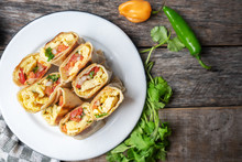 Mexican Egg Burritos With Fresh Sauce On Wooden Background
