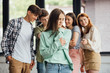panoramic shot of group of teenagers bullying girl