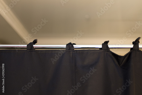 Fotomural black fabric curtains like a partition on a chrome pipe