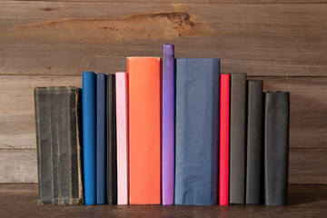 Many old books on wooden background.