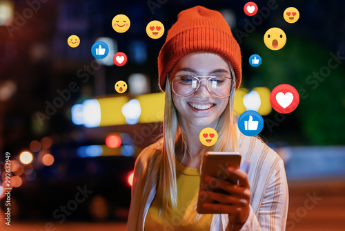 Cuadros en Lienzo A beautiful young woman blogger, vlogger or influencer is receiving emoji and em