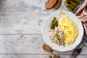 Canvas Print - Beef Stroganoff, traditional Russian dish of goulash with beef in creamy sauce, mashed potatoes and pickles. Serve with rustic bread