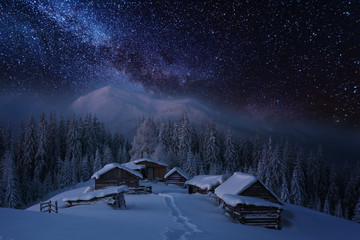 Wall Mural - fairytale landscapes of the winter carpathian mountains with a charming milky way in the sky tourist