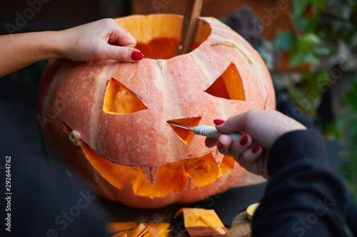 Young Fair Skinned Girl With Red Nails Carving A Face On A Pumpkin Creating Traditional Decoration For Halloween And Thanksgiving Day Kaufen Sie Dieses Foto Und Finden Sie Ahnliche Bilder Auf Adobe