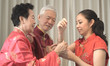 © glowonconcept - Asian parents give daughter in law gold bracket Chinese New Year