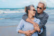 © Kiattisak - Happy asian couple senior elderly retirement resting at beach honeymoon family together happiness people lifestyle, copy space the left