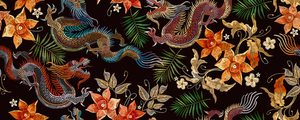 Embroidery asian dragon and beautiful yellow daffodils flowers seamless pattern. Oriental style. Japan and China art