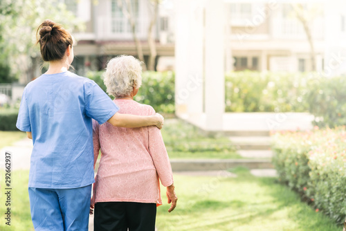 Cuadros en Lienzo nurse caregiver support walking with elderly woman outdoor