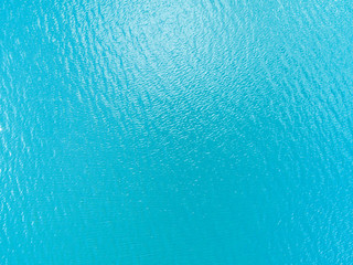 Aerial view of a Crystal clear sea water texture. View from above Natural blue background. Turquoise ripple water reflection in tropical beach. Blue ocean wave. Summer sea. Drone. Top view