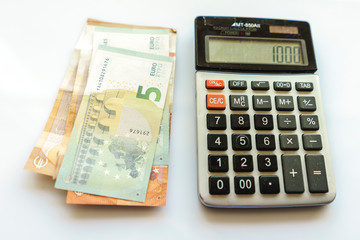 Banknotes and Calculator, Euro Banknotes on White Background