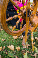 Wall Mural - woman in Russian national costume with spinning wheel and spindle