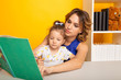 © burdun - Pretty family concept. Mom and daughter sitting together and studying at home