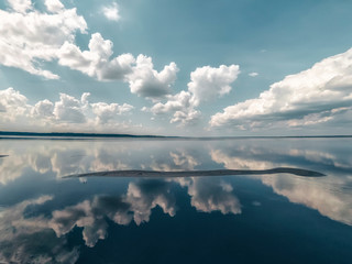 Wall Mural - Amazing landscape of the sea with reflection in the water the white clouds.