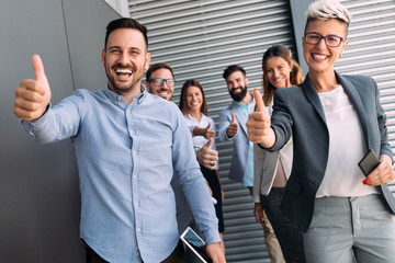 Business team celebrating a triumph with arms up