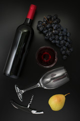 Wall Mural - Bottle of red wine, glass, corkscrew  and ripe grapes