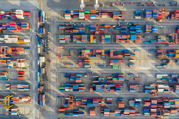 Aerial view. Container ship in pier with crane bridge carries out export and import business in the open sea. Logistics and transportation