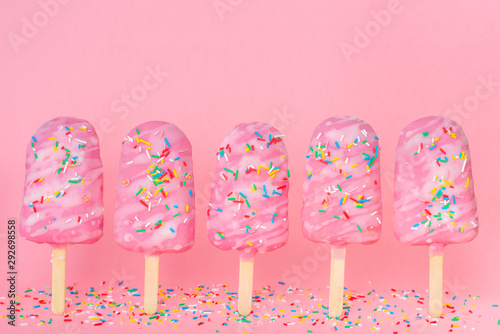 funny creative concept of unstable standing popsicle covered and strewed spri...