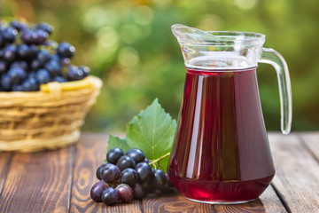 Wall Mural - grape juice in glass jug