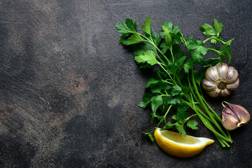 Wall Mural - Culinary background with spices : garlic, parsley and lemon. Top view with copy space.