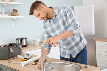 Poster - Plumber installing sink in kitchen