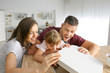 © Pixel-Shot - Happy family eating pizza at home