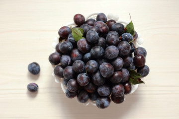 Wall Mural - blue plums from his garden on a wooden table