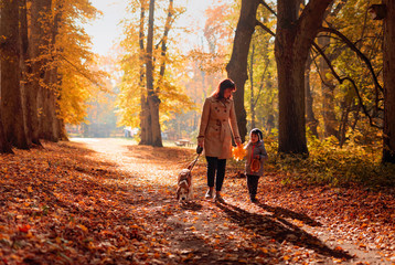 Happy young grandmother with granddaughter and dog.