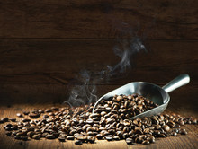 Coffee Beans With Scoop And Roasting Smoke