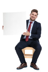 Wall Mural - happy young businessman holding empty white board