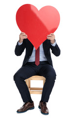 Poster - happy young businessman hiding behind big red heart