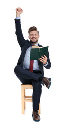 Poster - enthusiastic young businessman reading and holding arms up