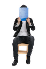 Sticker - seated casual man covering his face with clipboard