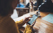 © A_B_C - in hands mobile phone empty screen, person type message on smartphone in cafe, relax tourist travels planning trip, hipster enjoy journey in cityscape, lifestyle holiday concept, internet online