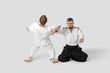 © Maygutyak - Two caucasian men are practicing aikido on the tatami (isolation path included)