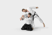 Two Caucasian Men Are Practicing Aikido On The Tatami (isolation Path Included)