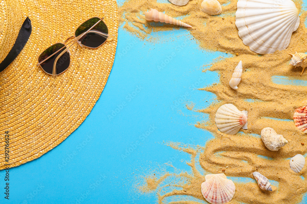 Summer composition with beach hat, sunglasses, sand and seashells on color background