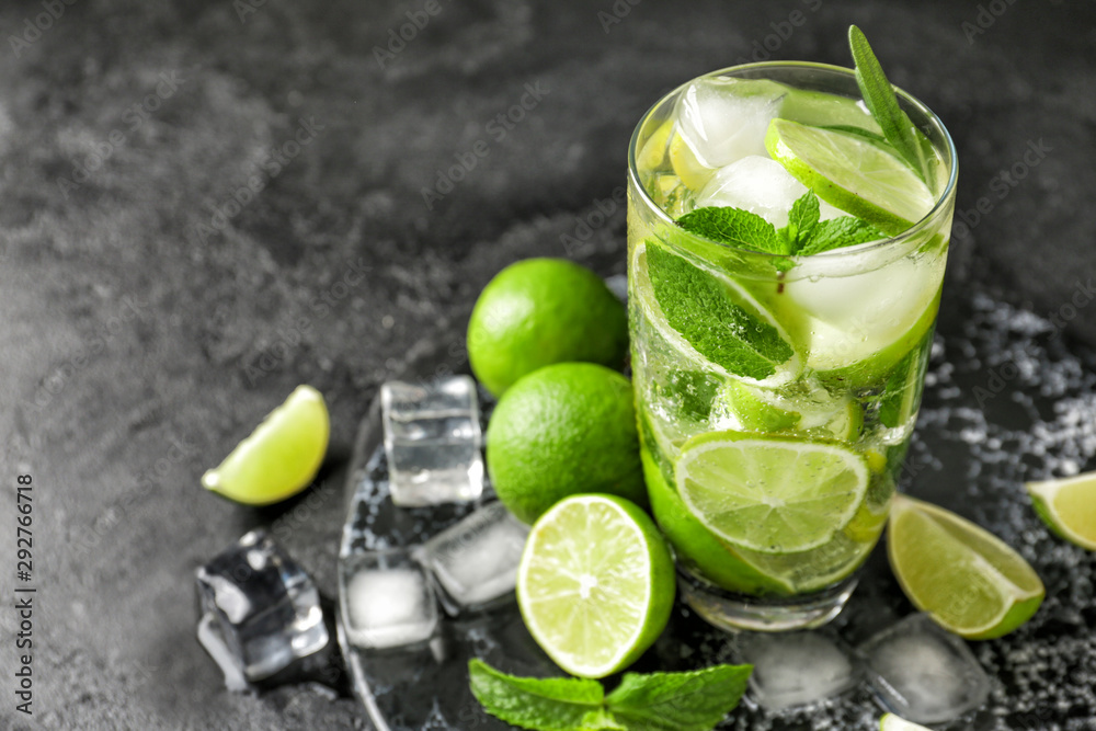 Glass of fresh mojito on dark background