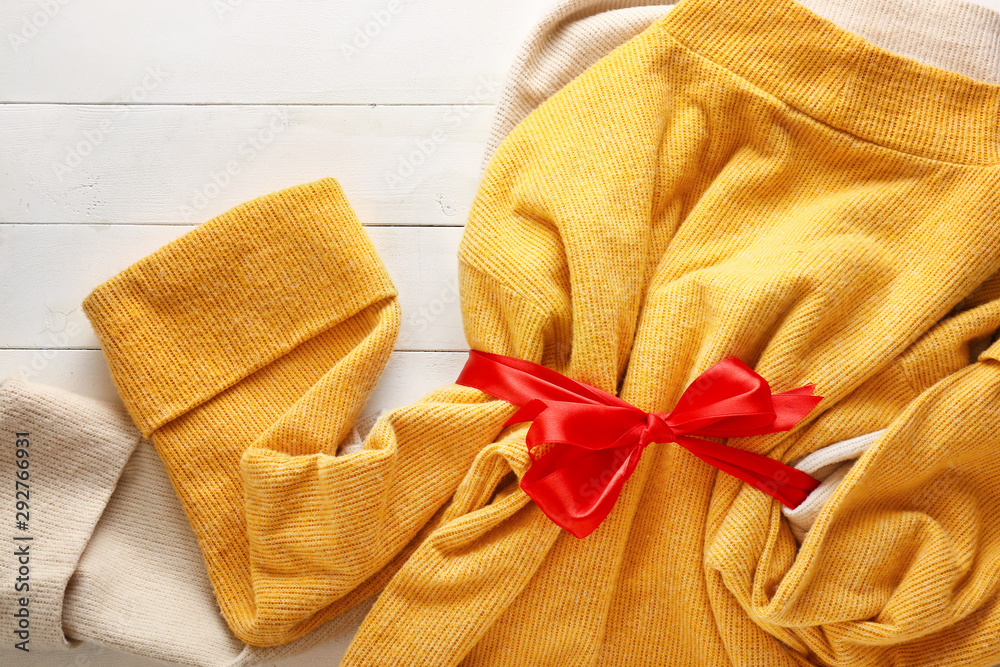 Warm Christmas clothes on white wooden background
