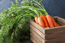 Wooden Box With Fresh Carrots On Table