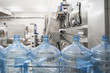 © DedMityay - Blue plastic bottles on automated conveyor line or belt on pure water factory