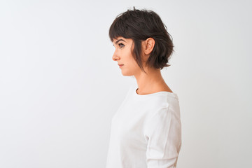 Young beautiful woman wearing casual t-shirt standing over isolated white background looking to side, relax profile pose with natural face with confident smile.