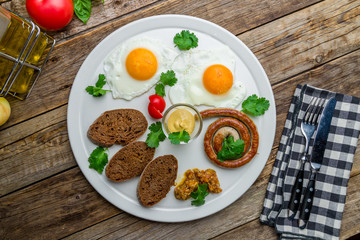 Wall Mural - English Breakfast on a plate on wooden table