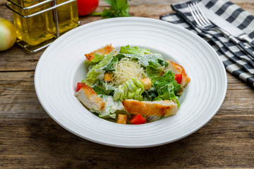 Canvas Print - Salad caesar with chicken on wooden table