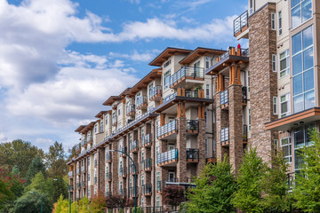 the top of an apartment building with nice windows.