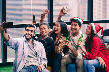 Group of friend enjoy the Christmas new year party with happiness. Friend drinking wine in the party.