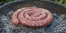 South African Boerewors Sausage Traditionally Cooked Outdoors On An Open Fire Image With Copy Space In Horizontal Format