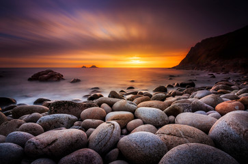 the sun sets at porth nanven in cornwall