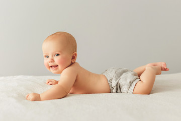 portrait of a cute 3 months baby lying down on a blanket